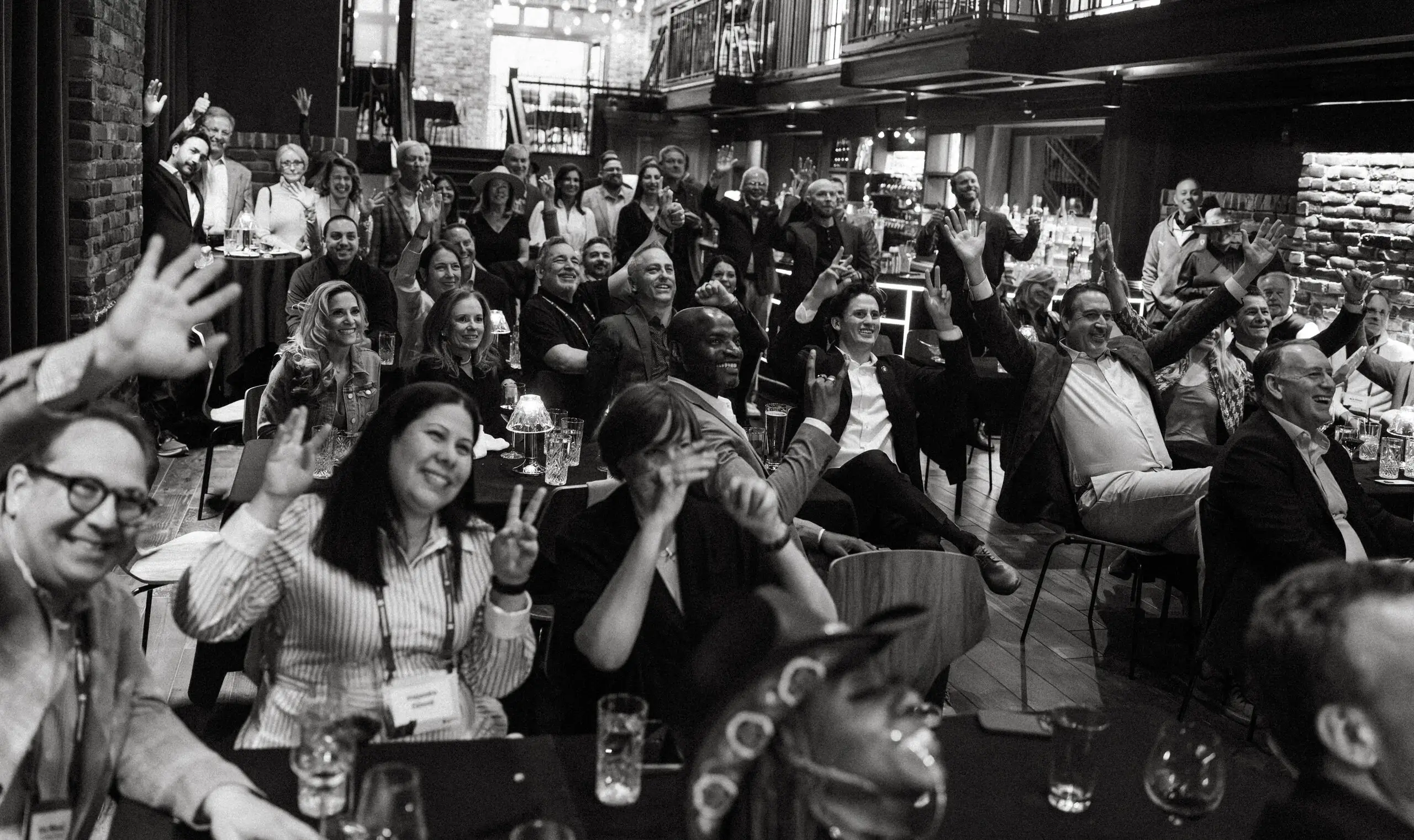 group of people cheering together at a gathering