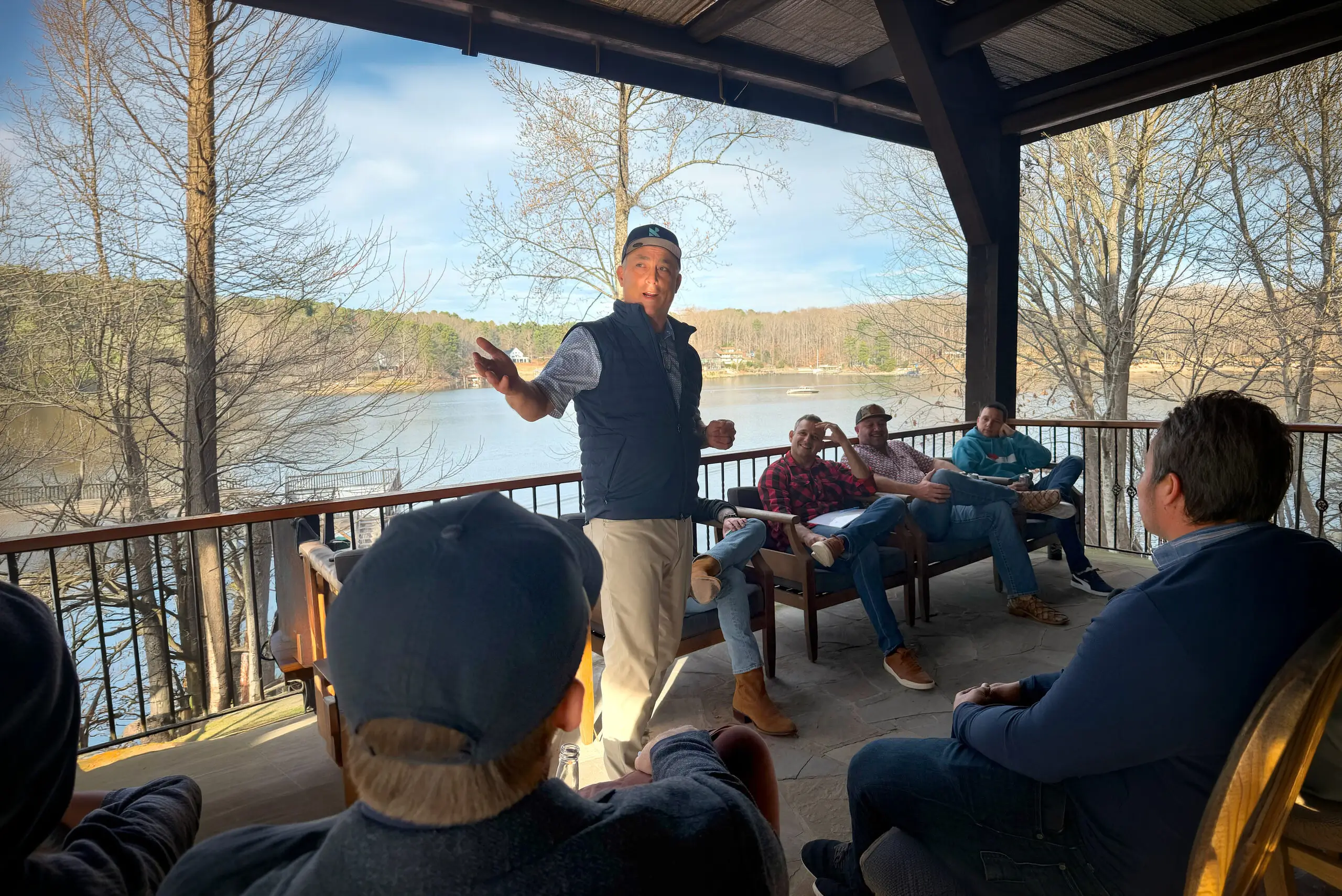 Board member leading a discussion on deck outdoors