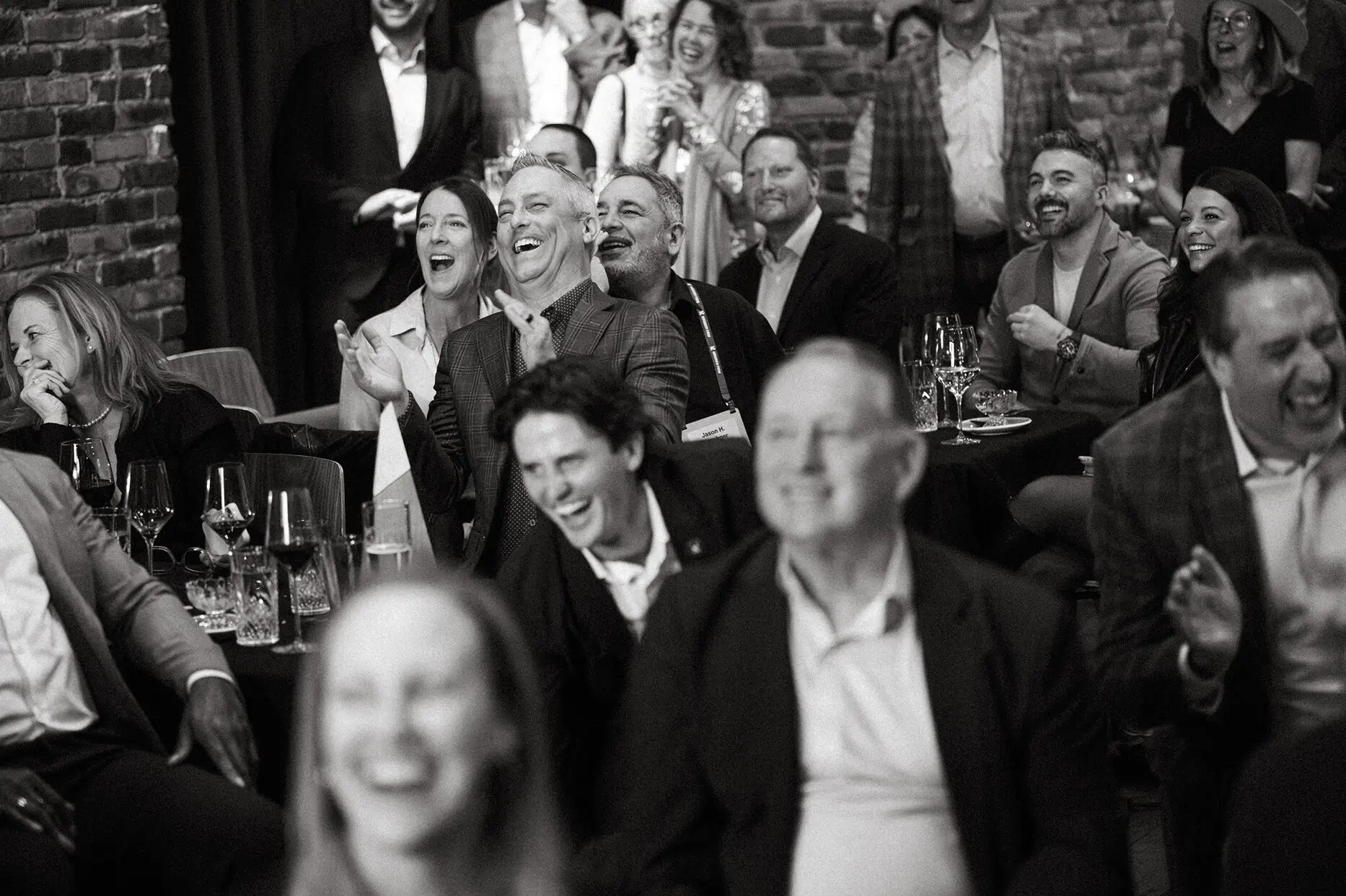 guests laughing together at dinner event